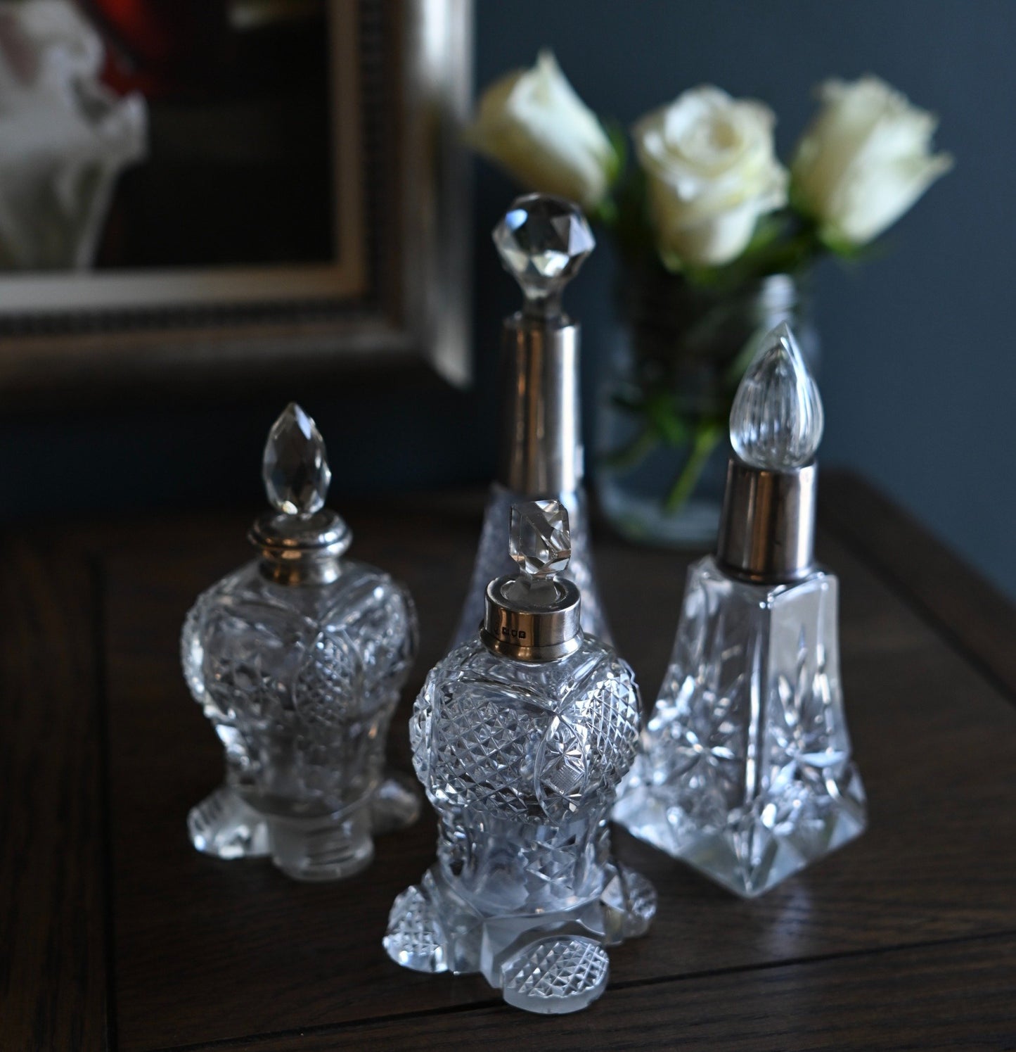 This delicate Edwardian-era perfume bottle is a graceful blend of craftsmanship and history. Featuring a flared cut crystal body with a fluted stopper.