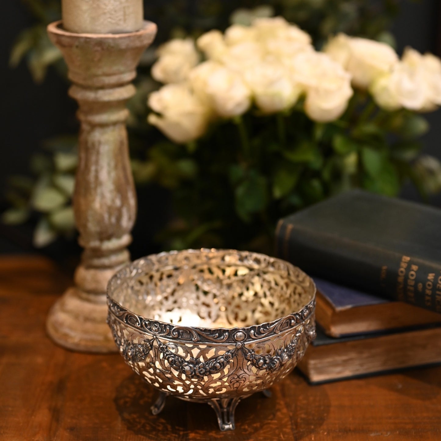 A romantic piece of early 20th-century craftsmanship, this German silver bowl features delicate openwork with swags of roses, birds in flight, and scrolling detail.