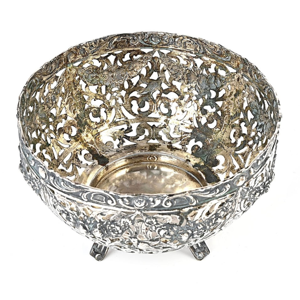 Decorative silver bowl with intricate filigree design on a white background