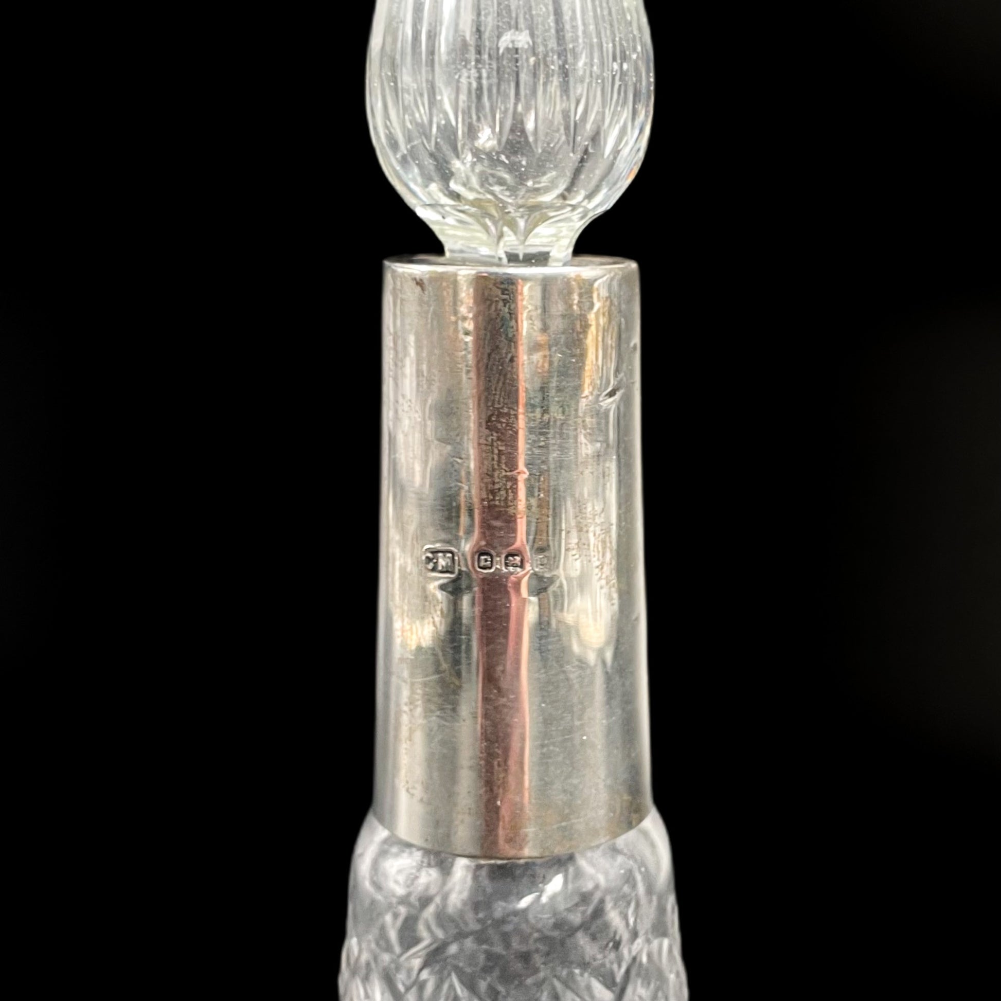Silver and crystal  perfume bottle hallmark on a black background