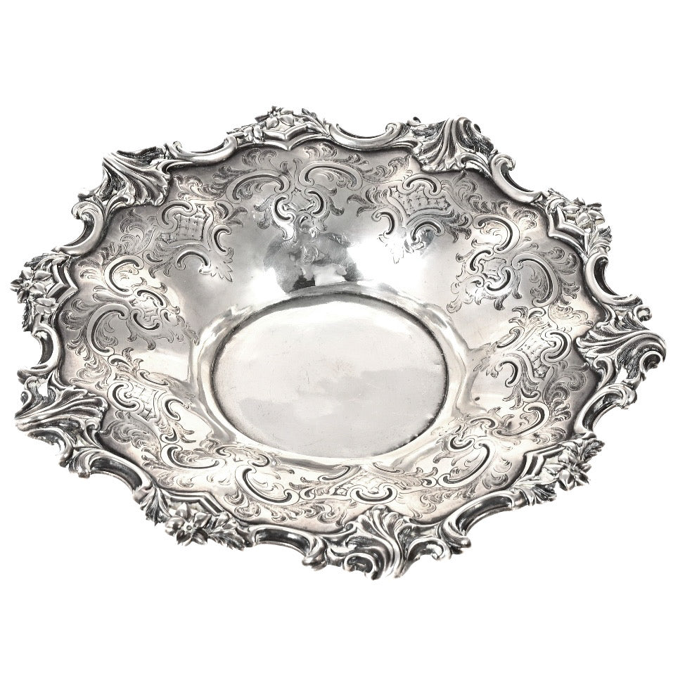 Decorative silver plate with intricate patterns on a white background