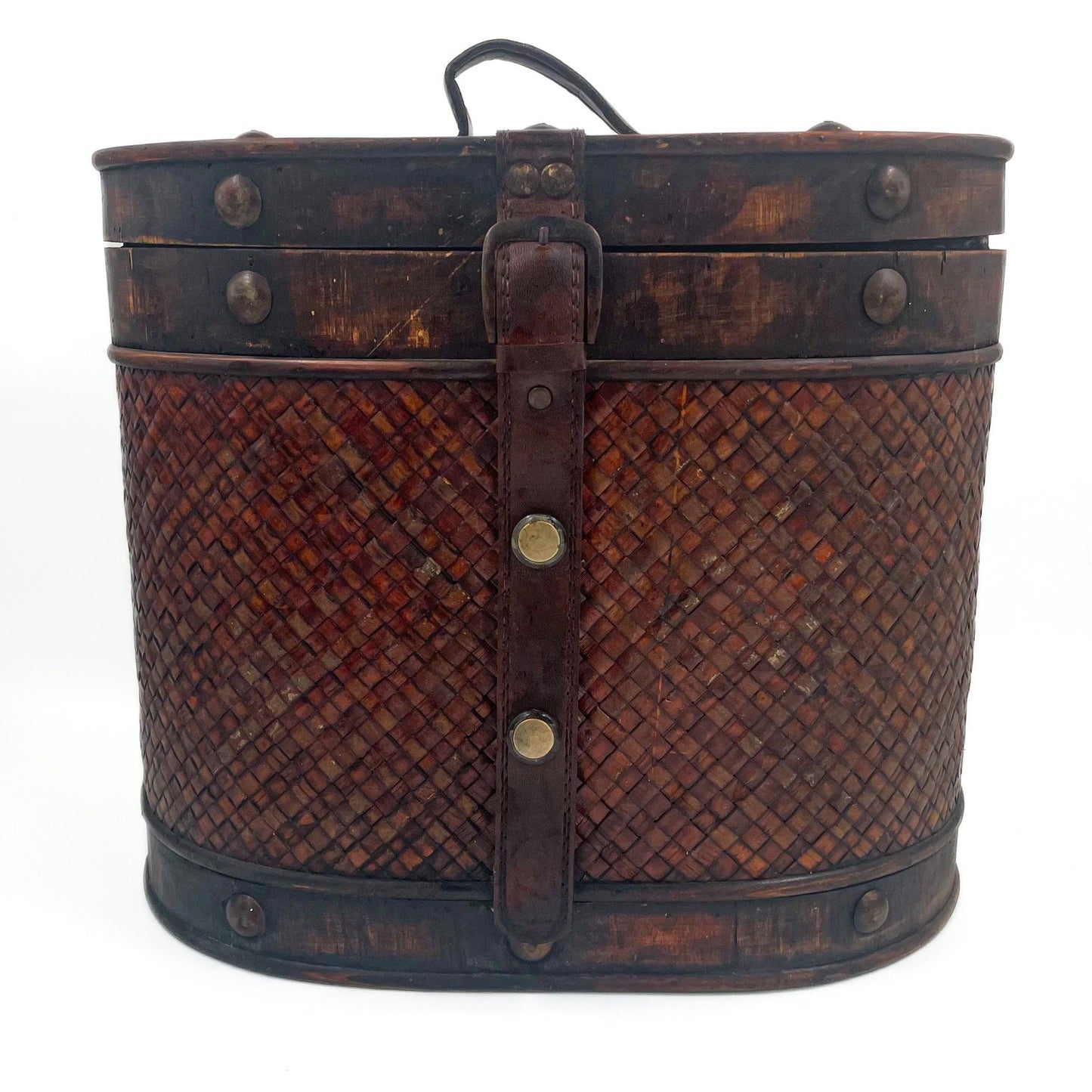 This antique storage box blends warm wood, woven lattice detail, and aged leatherette straps for a richly textured, timeworn look.