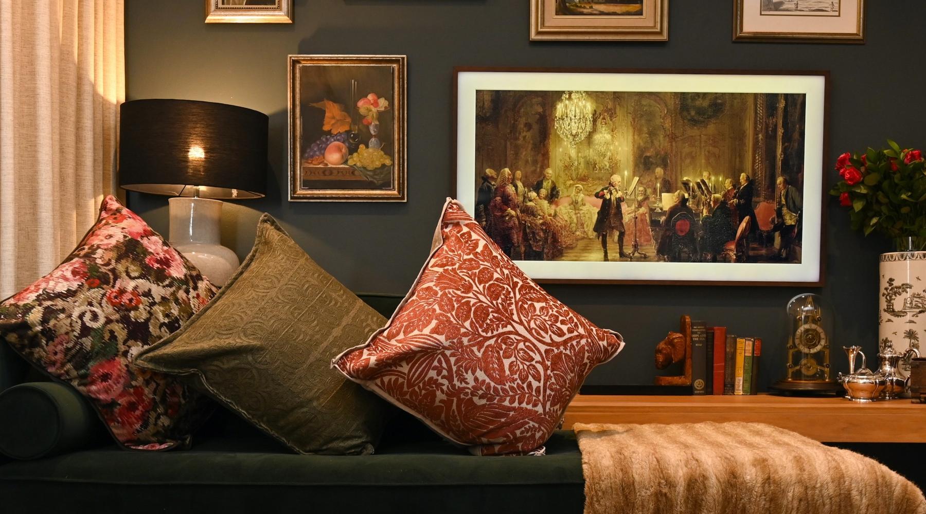 Decorative living room with dark walls, framed art, and patterned cushions.