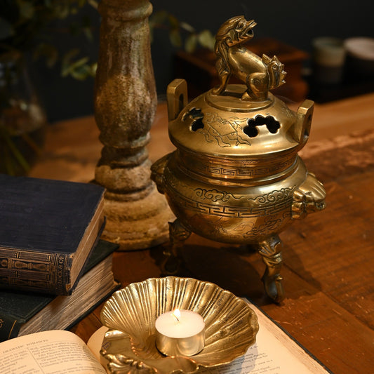 This solid brass Chinese incense burner, topped with a foo dog symbolizes protection and guardian spirit energy.  Cira 1950's.