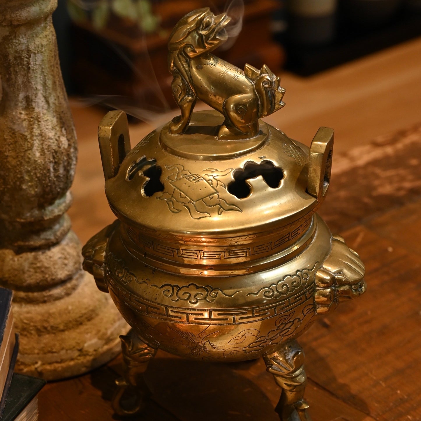 This solid brass Chinese incense burner, topped with a foo dog symbolizes protection and guardian spirit energy. Cira 1950's.