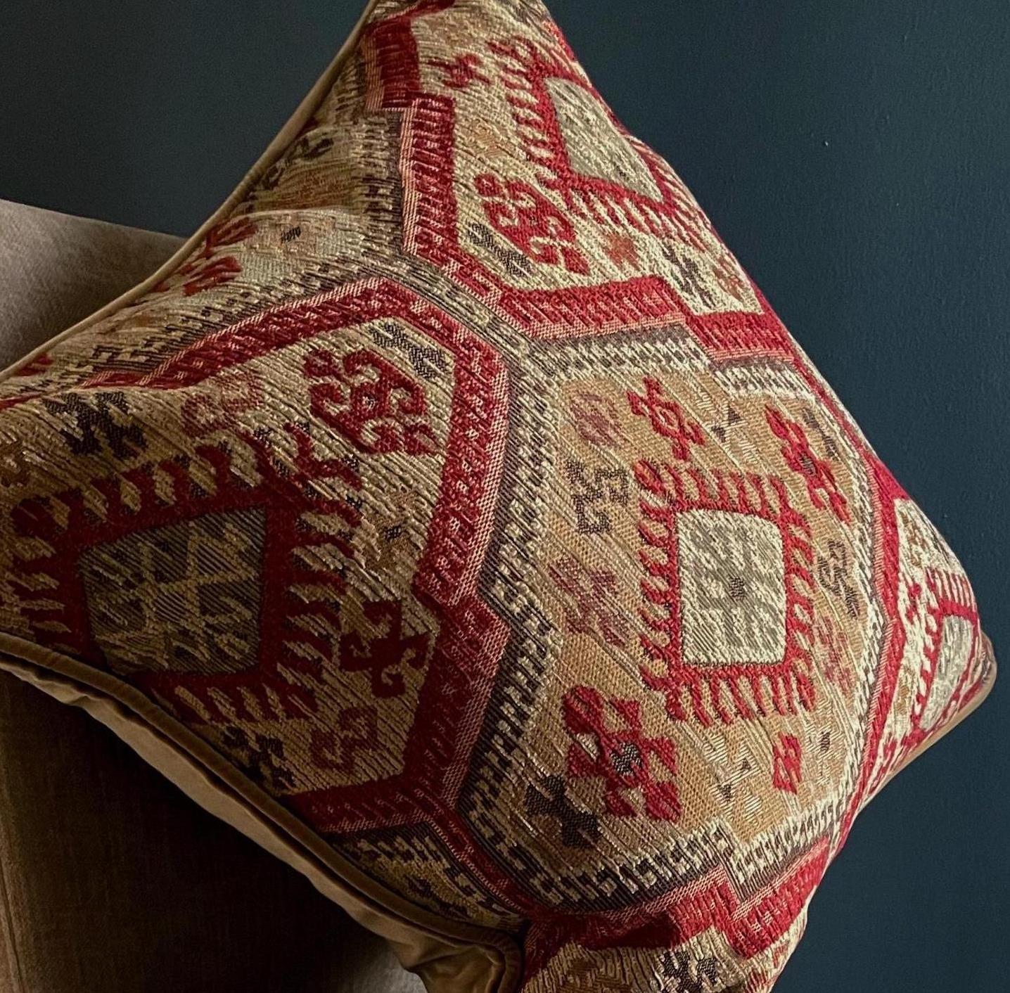 Decorative pillow with intricate geometric pattern on a dark background