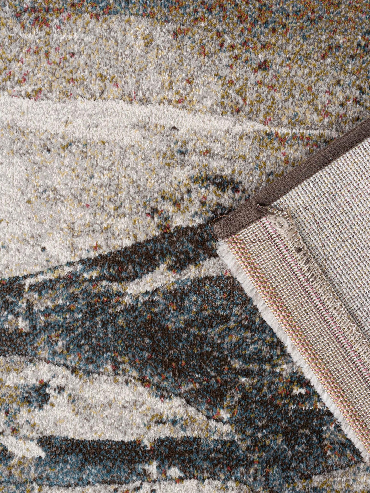 Close-up of a textured rug with a border
