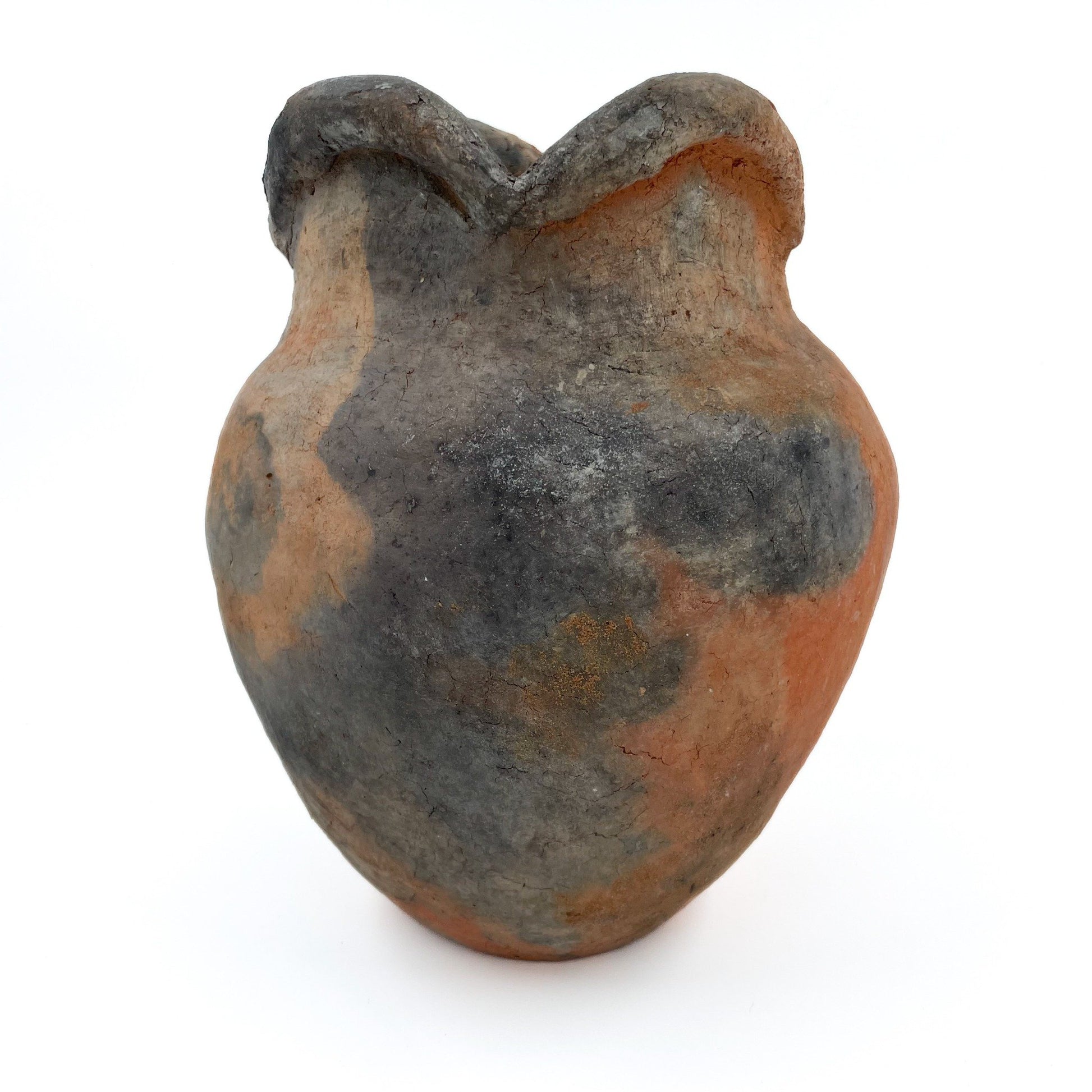 Handcrafted in Namibia using ancient nomadic techniques, this earthenware vase is shaped from natural clay and kiln-fired directly in the ground.