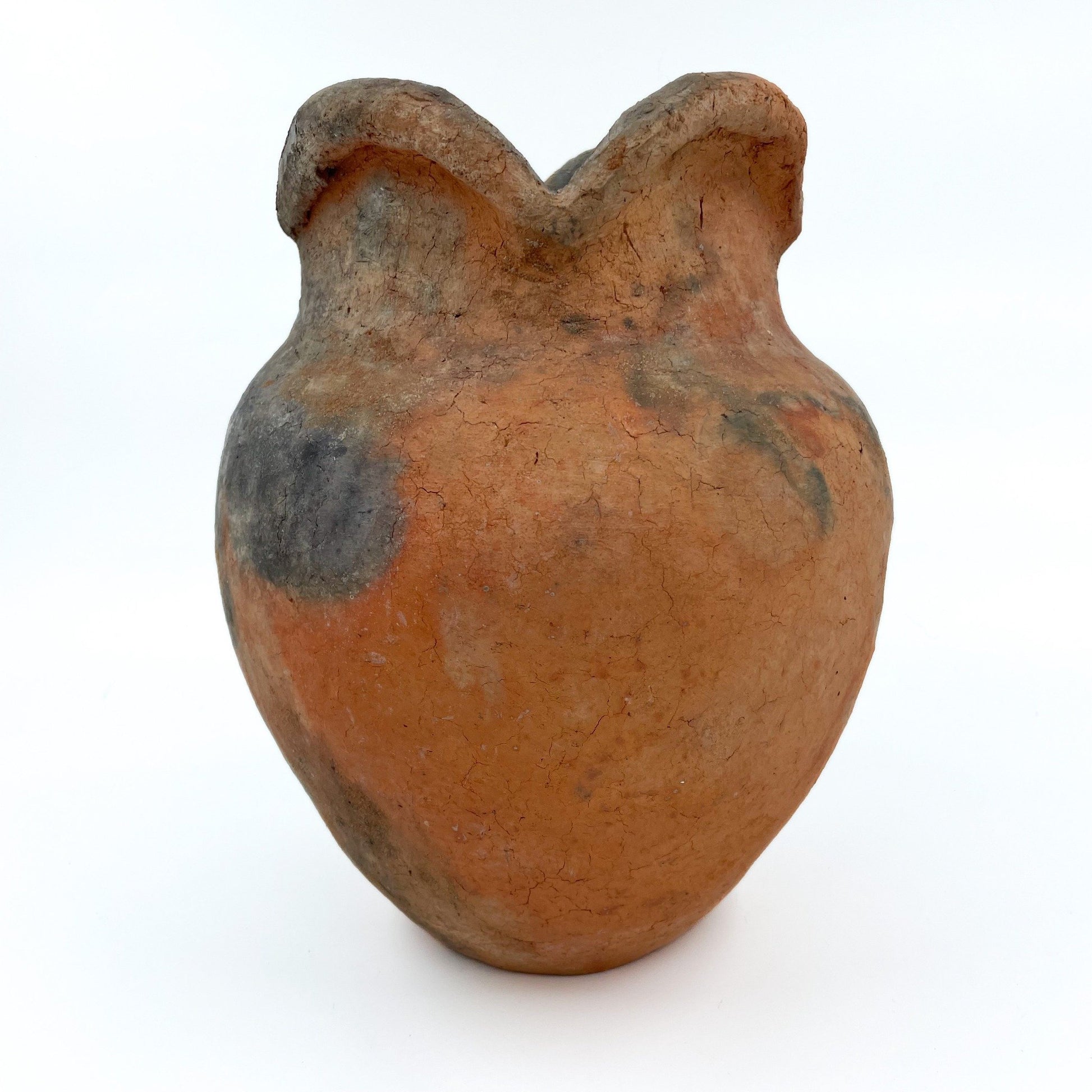 Handcrafted in Namibia using ancient nomadic techniques, this earthenware vase is shaped from natural clay and kiln-fired directly in the ground.