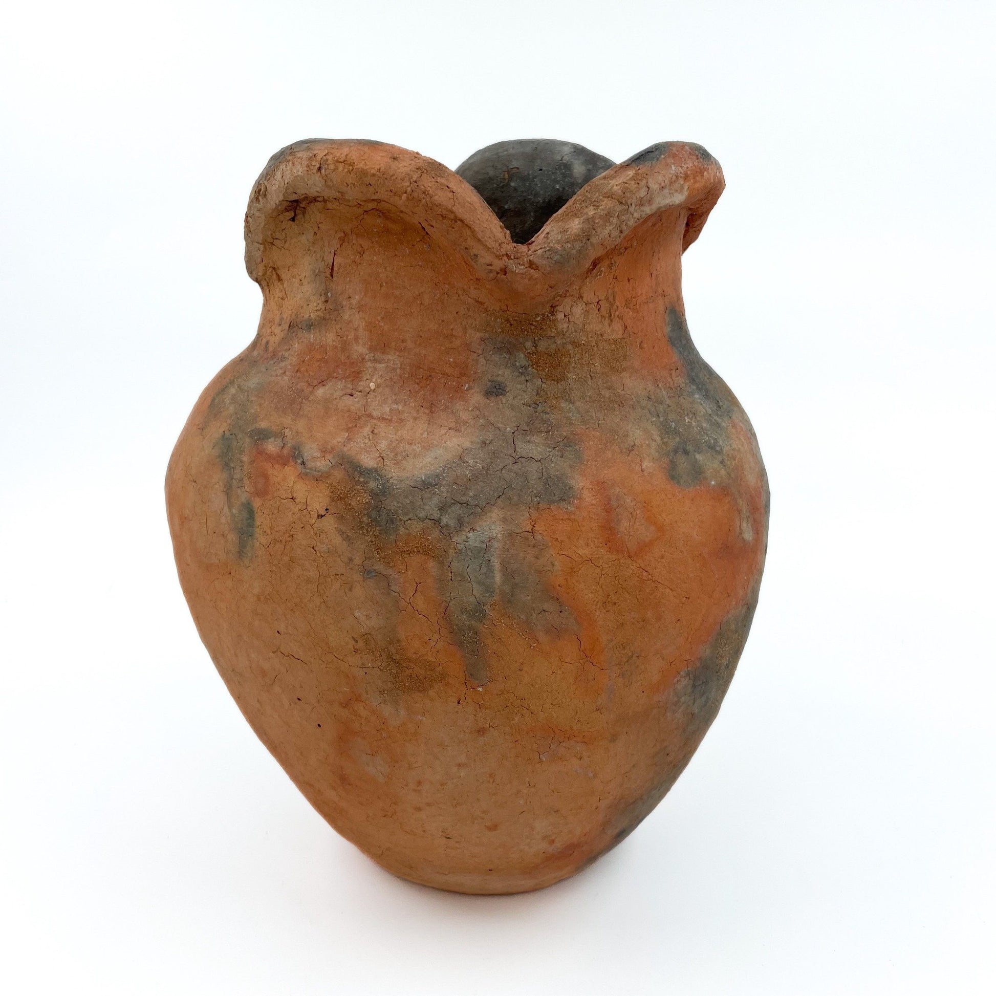 Handcrafted in Namibia using ancient nomadic techniques, this earthenware vase is shaped from natural clay and kiln-fired directly in the ground.