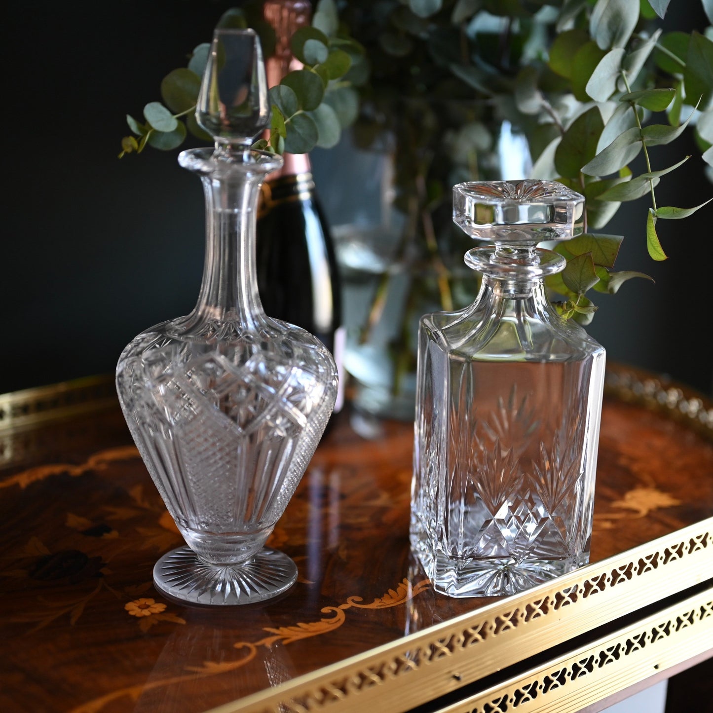 A timeless pairing of cut crystal decanters, each offering its own distinct silhouette and elegance.
