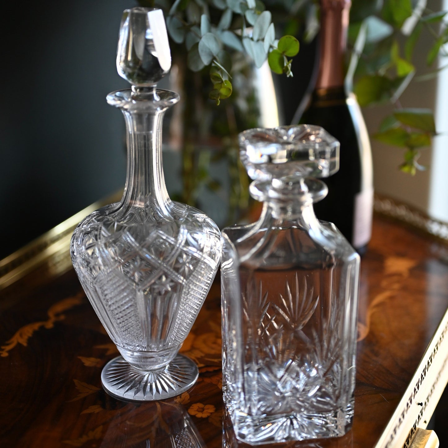 A timeless pairing of cut crystal decanters, each offering its own distinct silhouette and elegance.