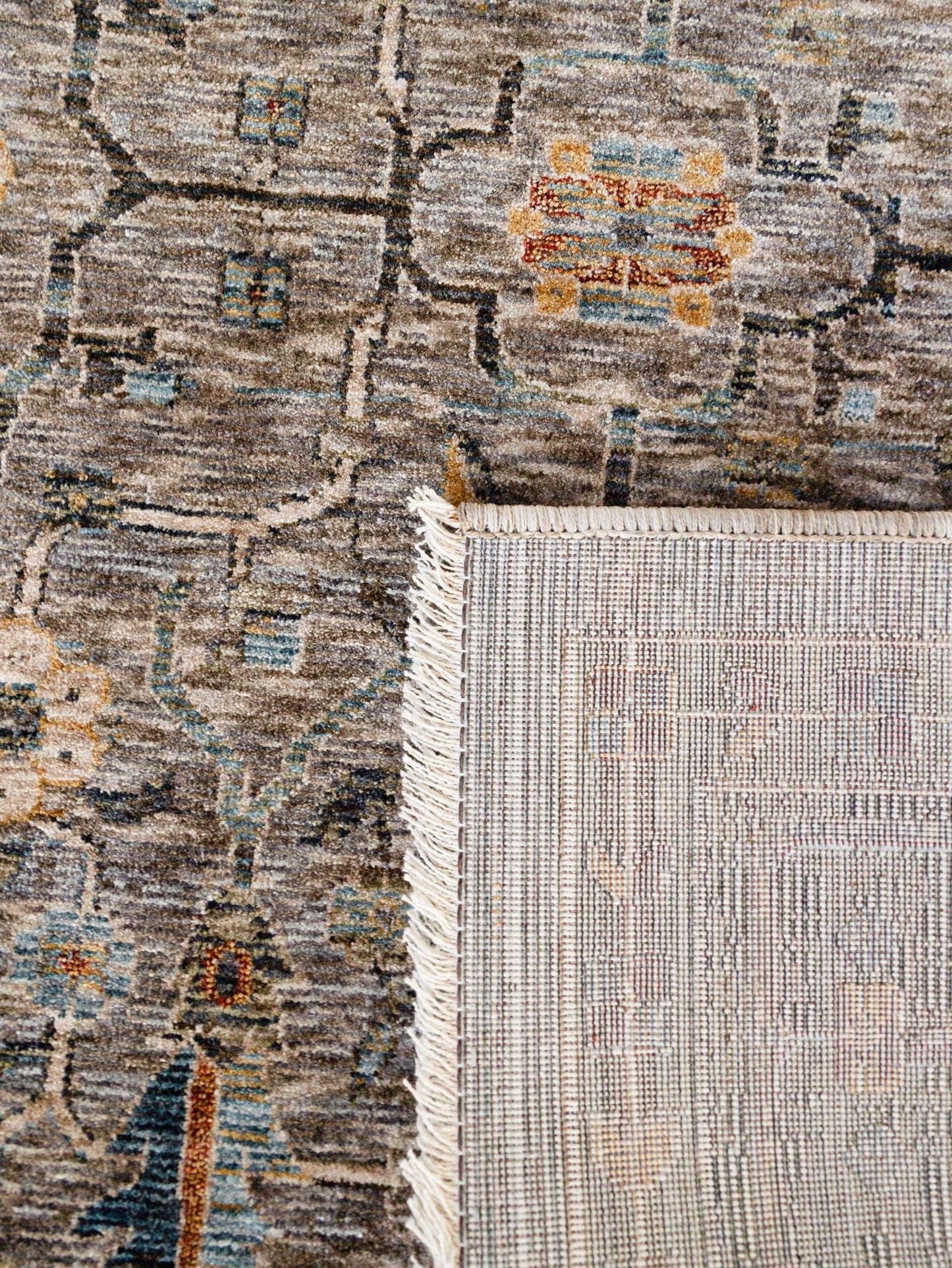 Close-up of two patterned rugs with a visible transition area.