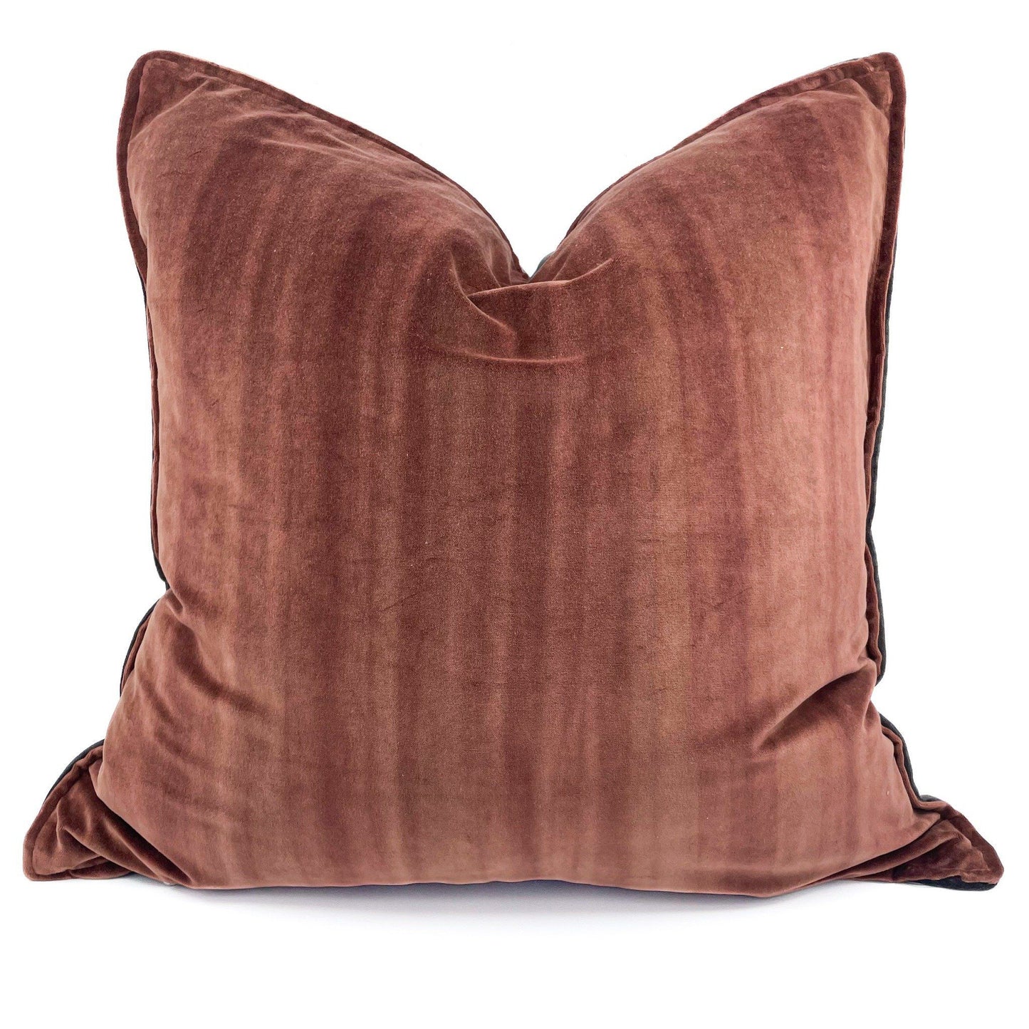 Rust velvet pillow on a white background