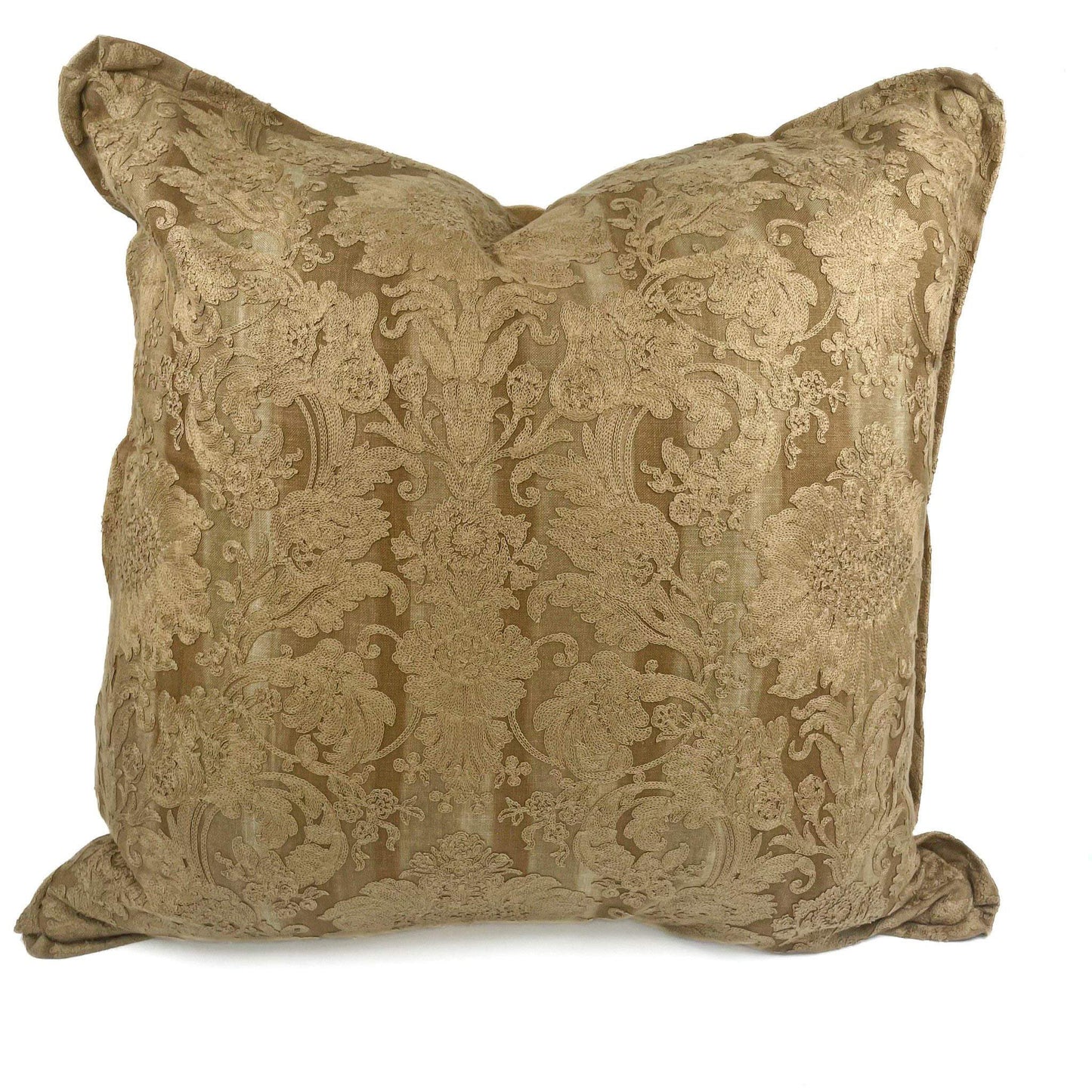 Decorative pillow with intricate gold pattern on a white background