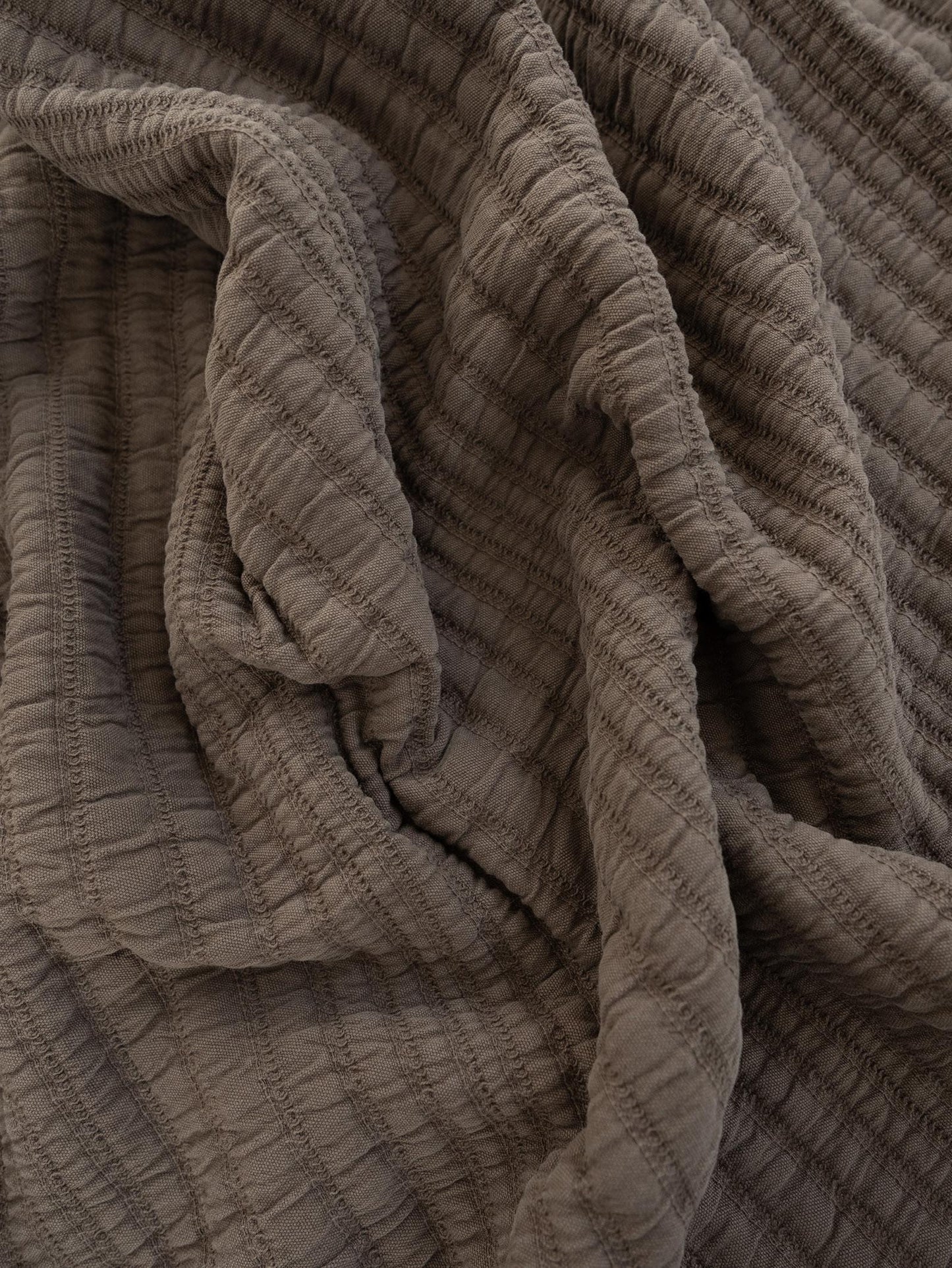 Close-up of textured mocha colour throw