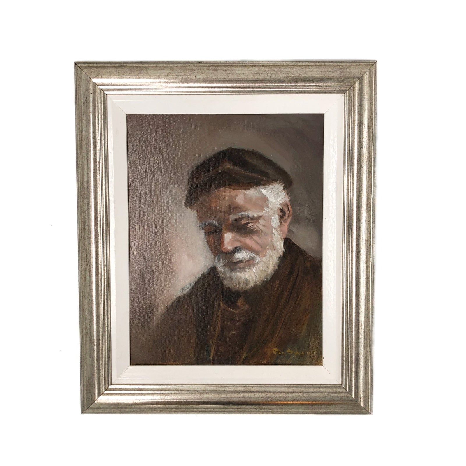 Framed painting of an elderly man with a white beard and cap on a white background