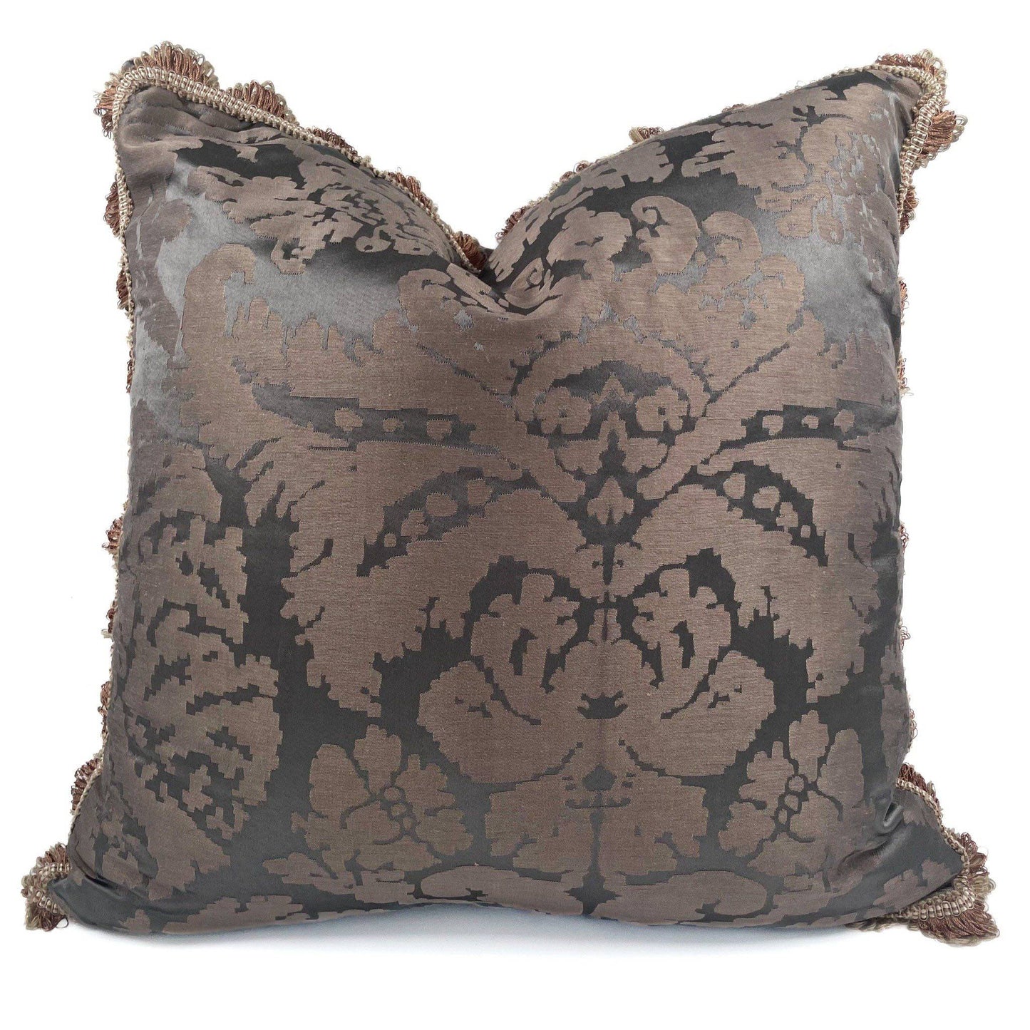 Decorative pillow with intricate pattern and tassels on a white background