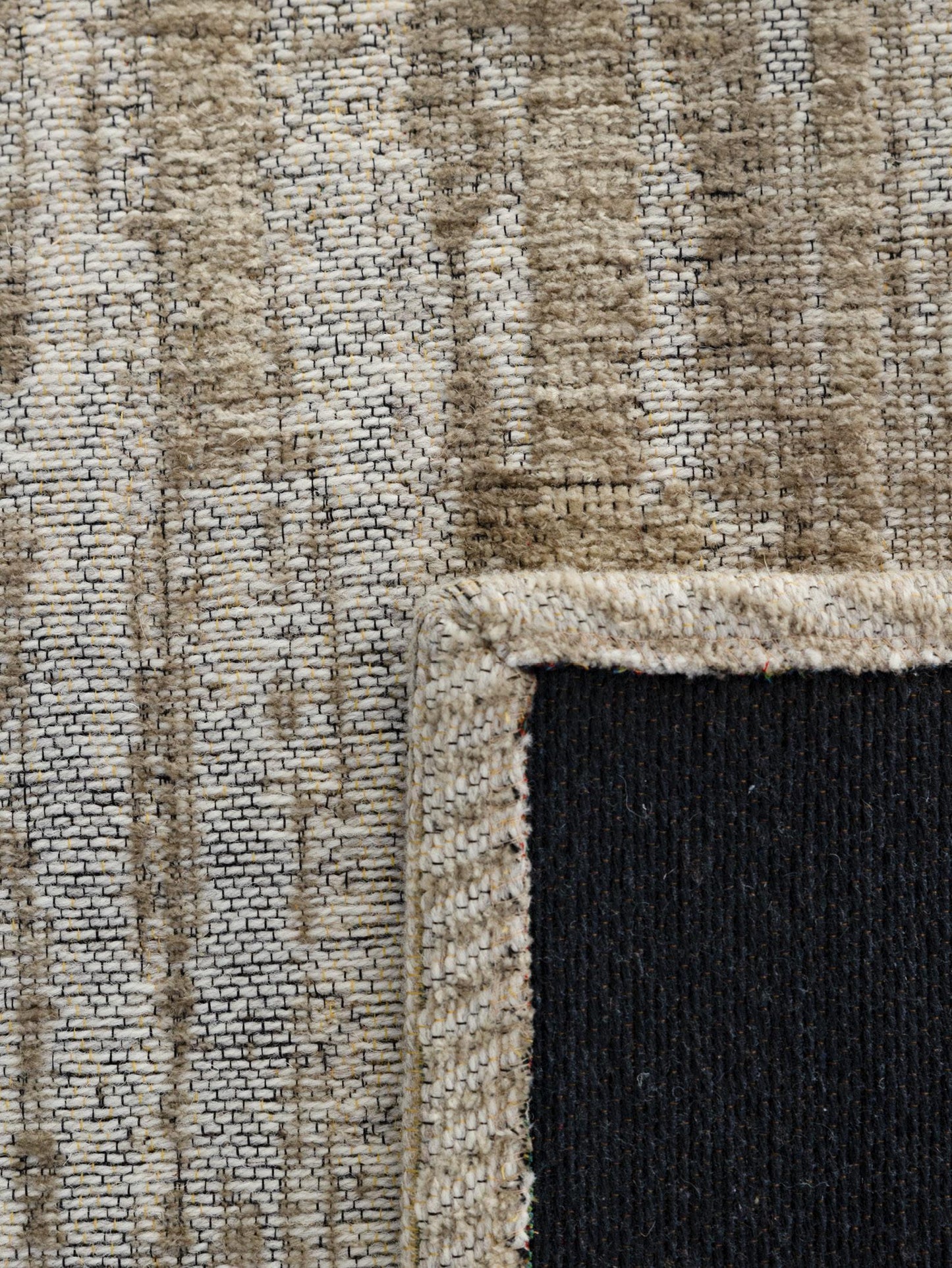 Close-up of a textured rug with a border