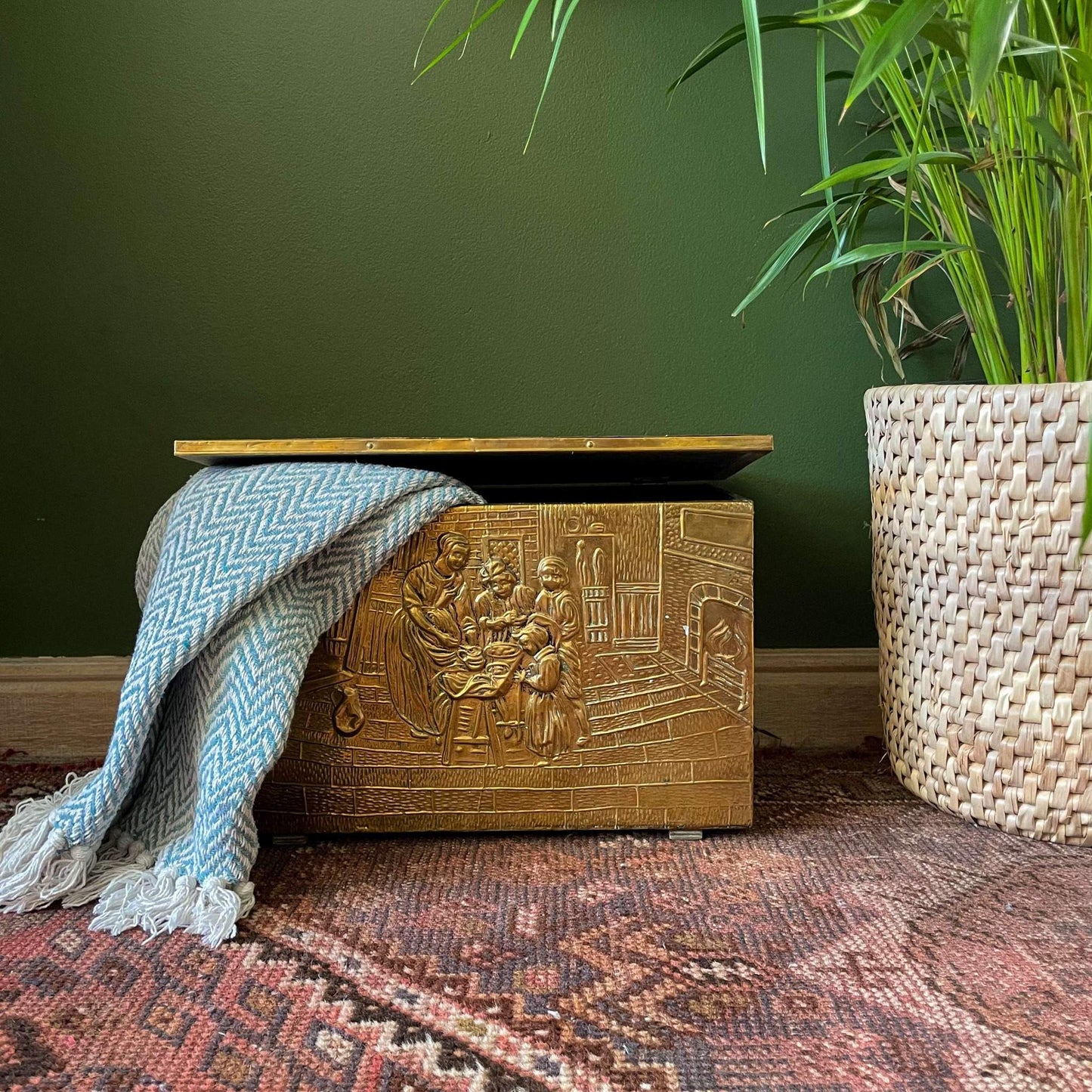 An embossed brass box from the late 19th century, crafted using repoussé techniques, depict a scenes of historical domestic life evoking a sense of nostalgia and tradition.