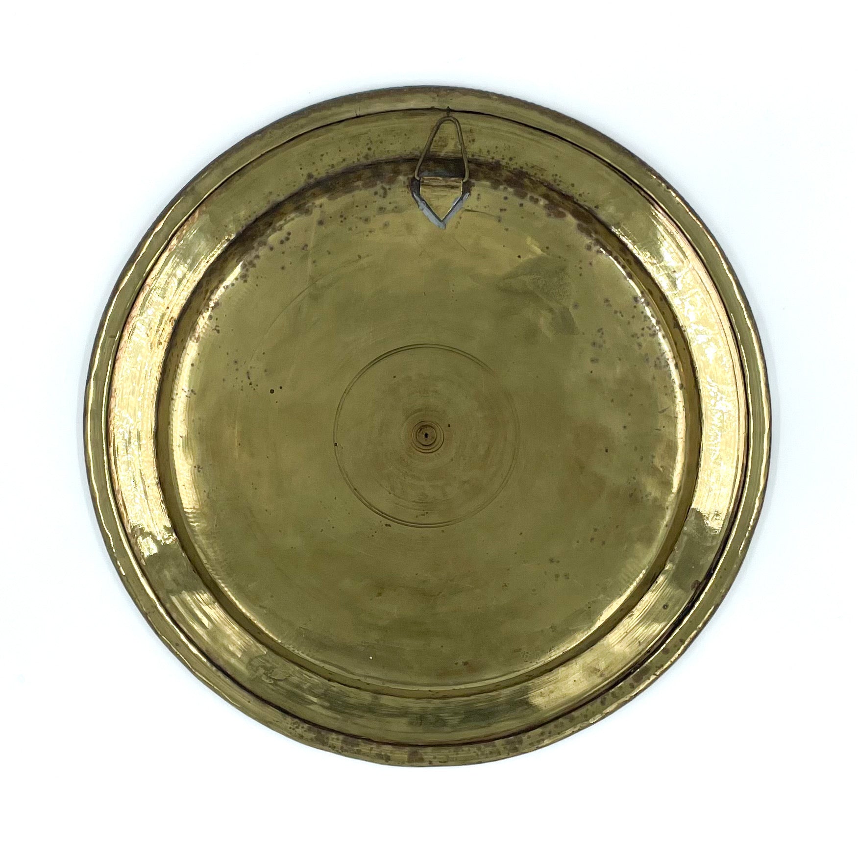 Back view of a solid ornate and intricately designed Persian metalwork tray or wall plate showcases detailed geometric patterns and calligraphy, made from a combination of brass, copper and silver.