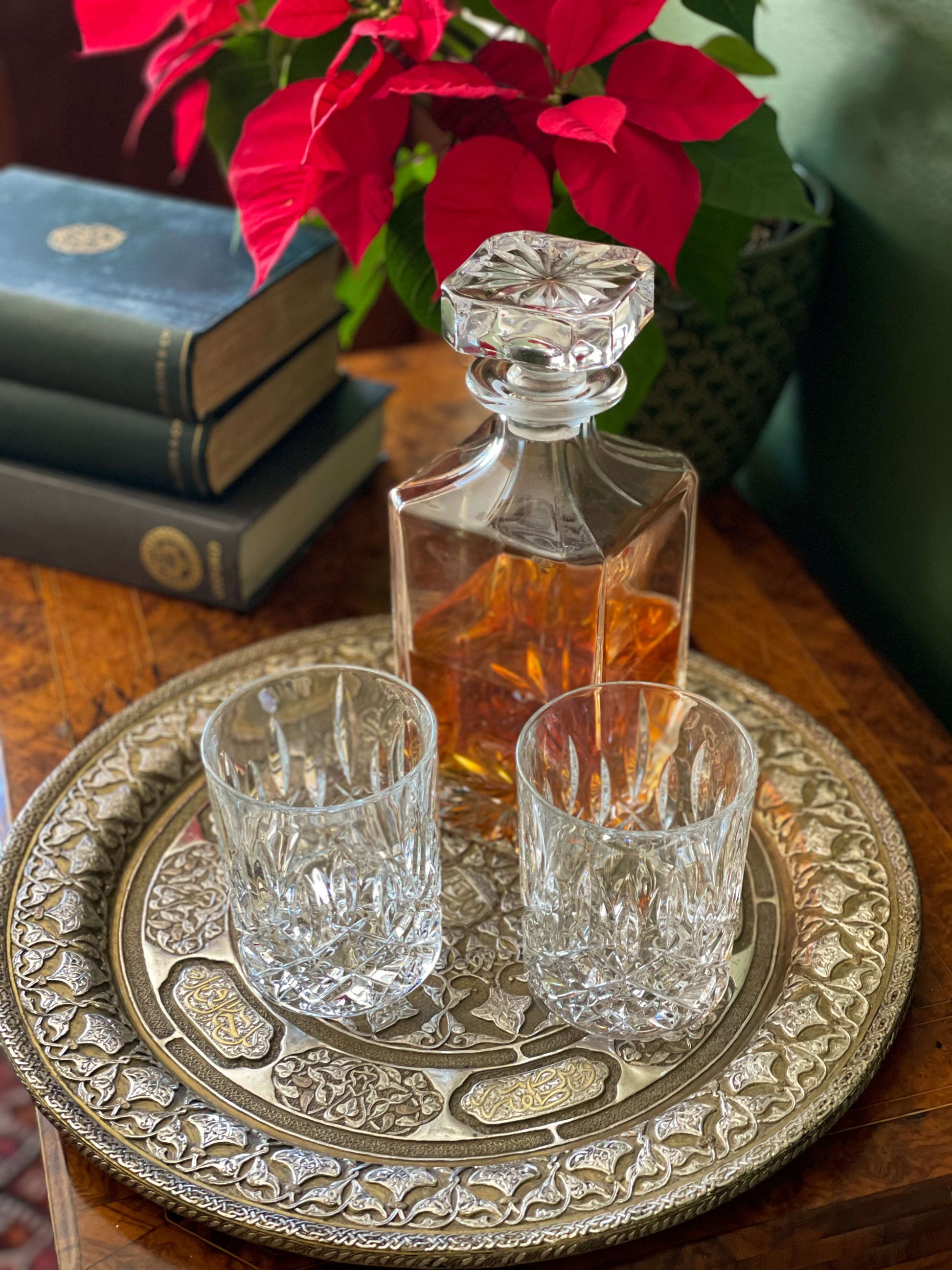 A solid ornate and intricately designed Persian metalwork tray or wall plate showcases detailed geometric patterns and calligraphy, made from a combination of brass, copper and silver.