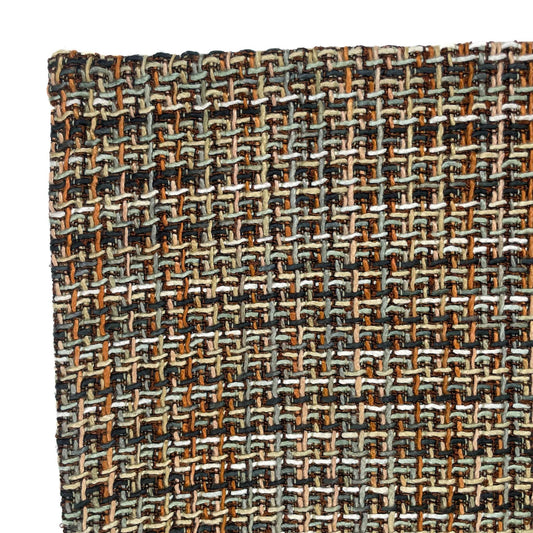 Close-up of a woven fabric with a multicolor pattern on a white background