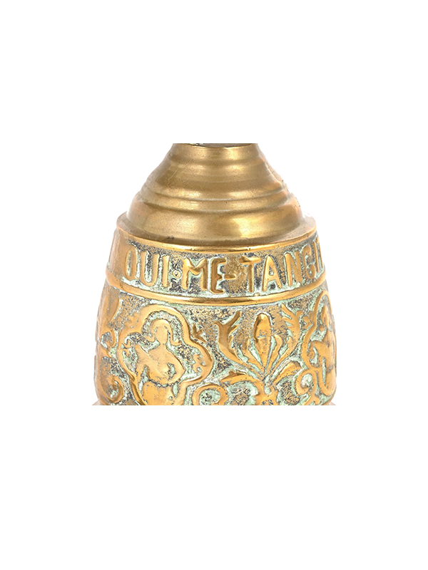 Decorative antique brass bell with intricate patterns on a white background