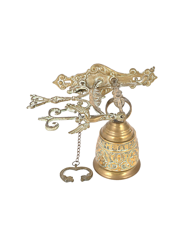 Decorative antique brass bell with intricate designs on a white background
