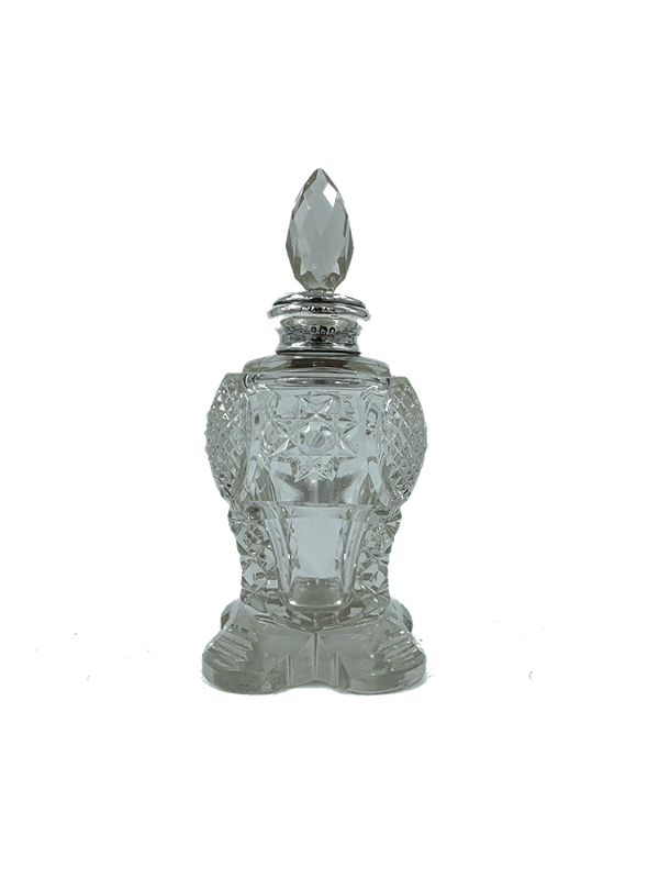 Antique crystal perfume bottle with silver collar and intricate design on a white background