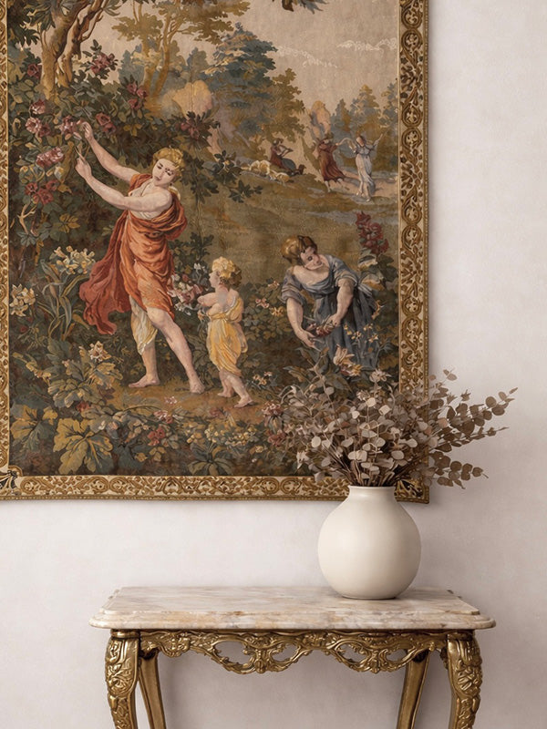 Decorative tapestry with classical scene above a marble table with a vase.