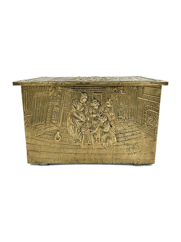 Antique brass decorative storage or firewood box with intricate carvings on a white background