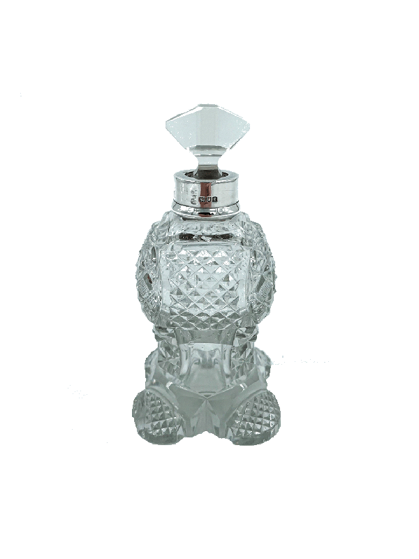 Decorative antique silver and crystal perfume bottle with a silver cap on a white background