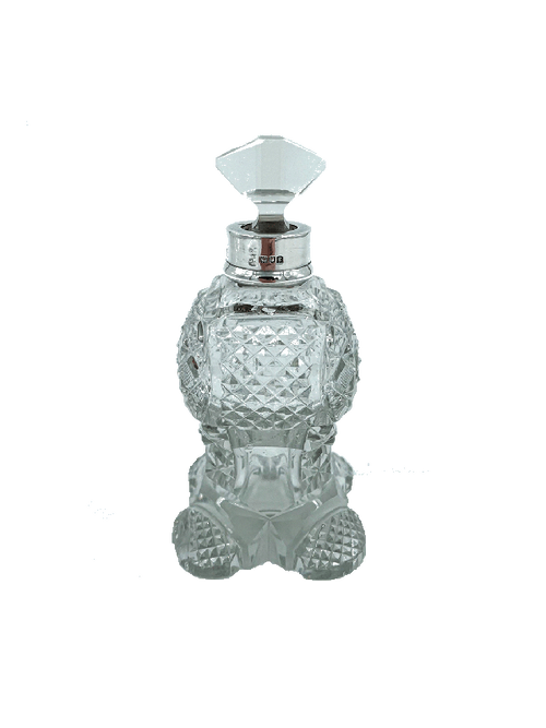 Decorative antique silver and crystal perfume bottle with a silver cap on a white background