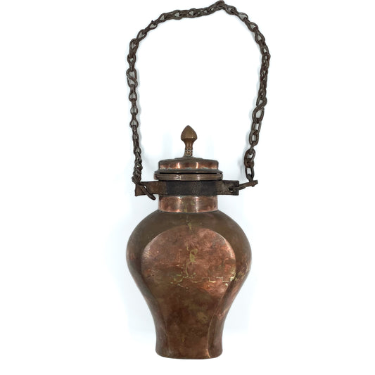 Front view of an antique copper water canteen dating back to the early 19th century.
