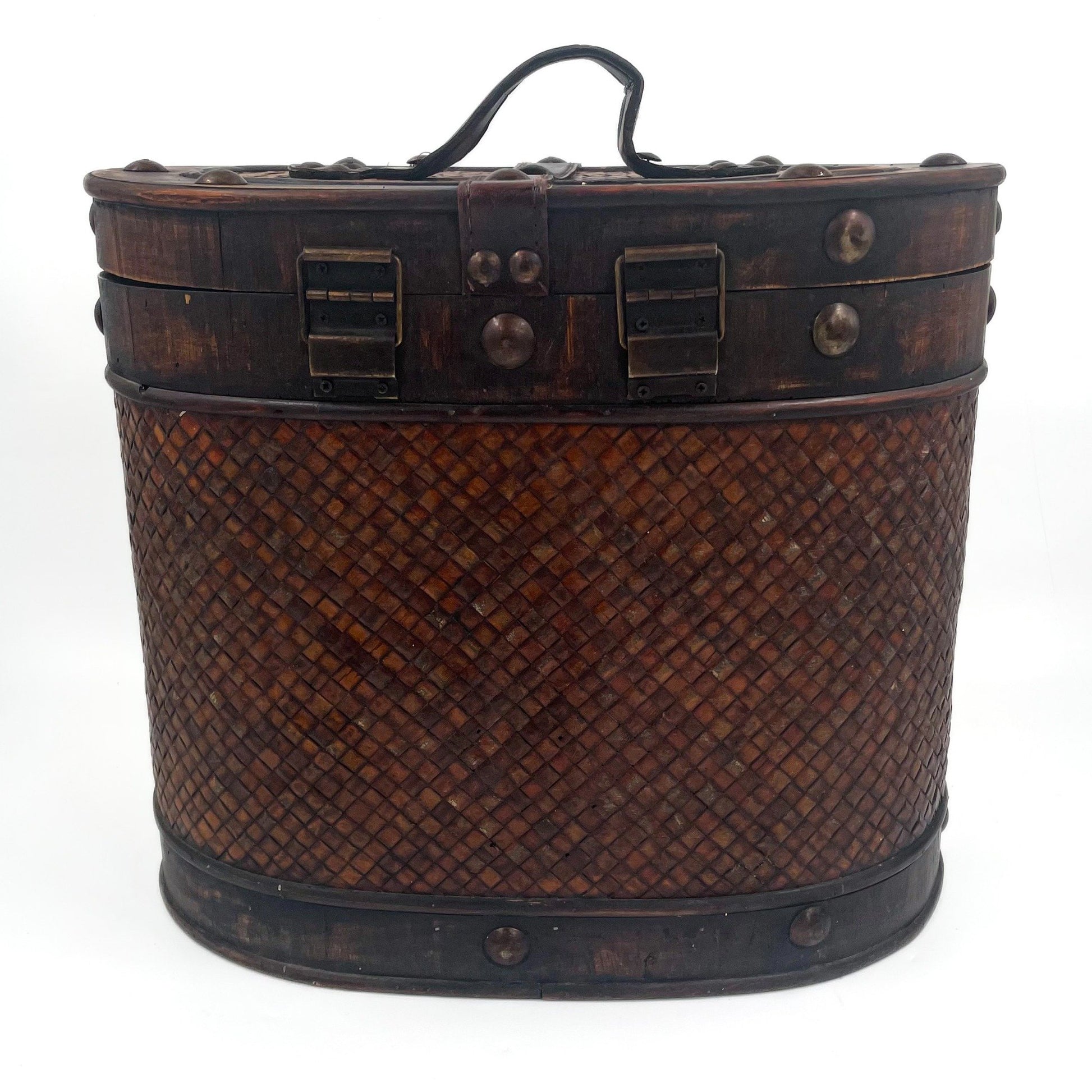 This antique storage box blends warm wood, woven lattice detail, and aged leatherette straps for a richly textured, timeworn look.