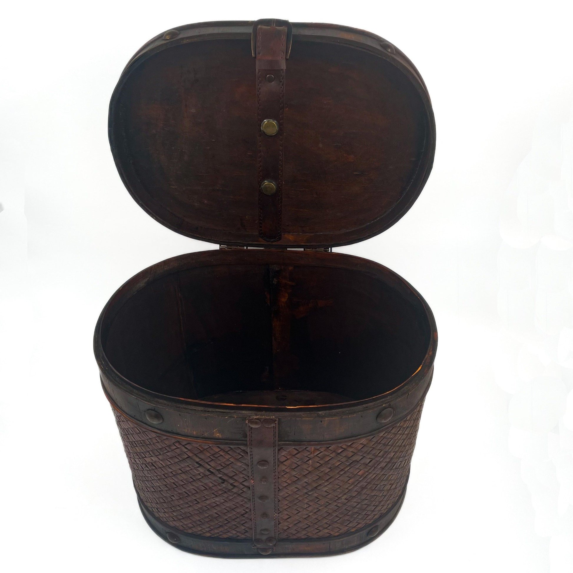 This antique storage box blends warm wood, woven lattice detail, and aged leatherette straps for a richly textured, timeworn look.