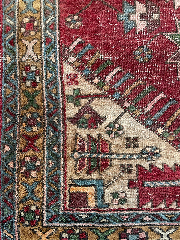 Close-up of a patterned rug with intricate designs and vibrant colors.