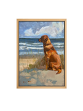 Framed oil artwork of a dog sitting on a beach with ocean and sky in the background.