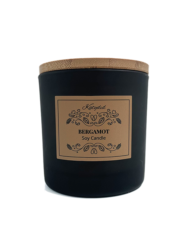 Black candle with a brown label on a white background