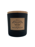 Black candle with a brown label on a white background