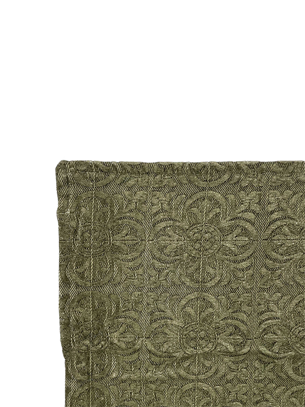 Close-up of a textured green fabric  for scatter cushion with intricate patterns on a white background