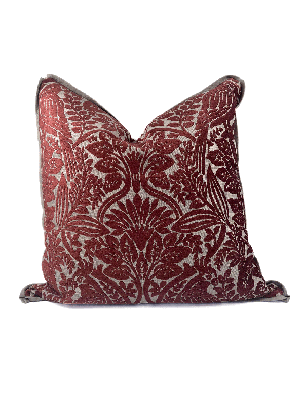 Decorative red velvet cut out scatter cushion with red floral pattern on a white background