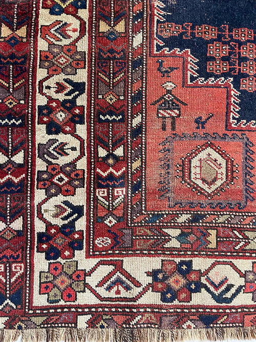 Close-up of a patterned rug with intricate designs and colors.