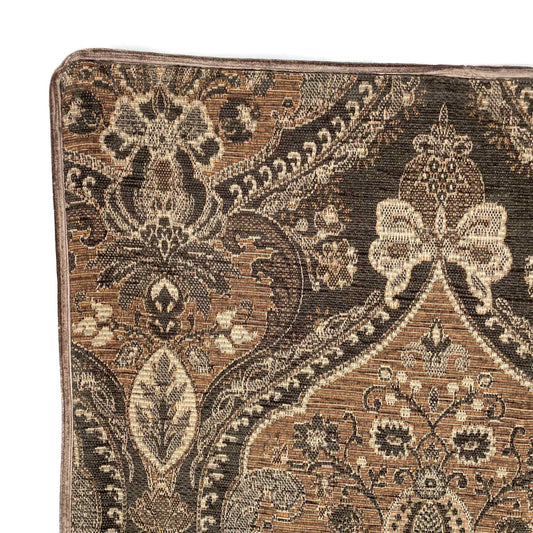 Close-up of a patterned rug with intricate designs on a white background