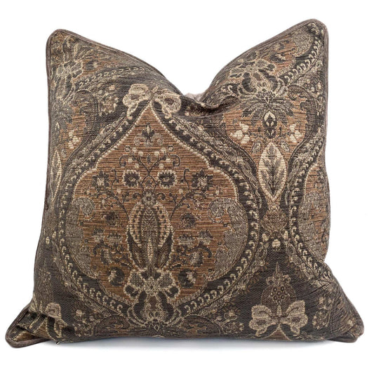 Decorative pillow with intricate brown and beige pattern on a white background