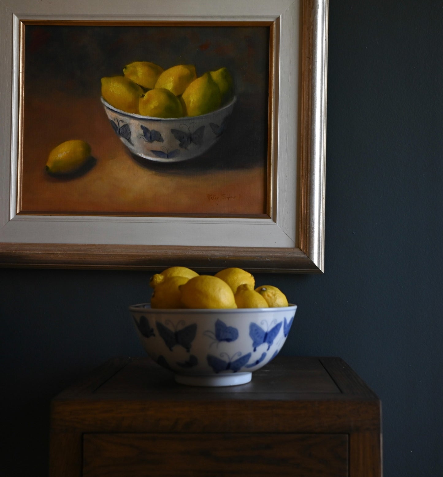 Golden Abundance captures the gentle radiance of ripe lemons nestled in a butterfly-adorned porcelain bowl, painted in warm, glowing tones.