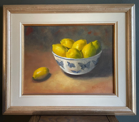 Golden Abundance captures the gentle radiance of ripe lemons nestled in a butterfly-adorned porcelain bowl, painted in warm, glowing tones.