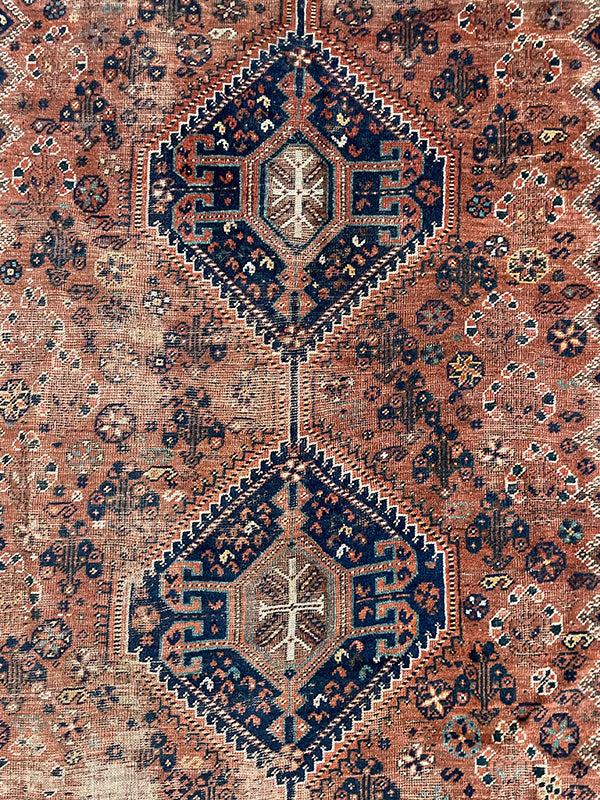 Close-up of a patterned rug with geometric designs.