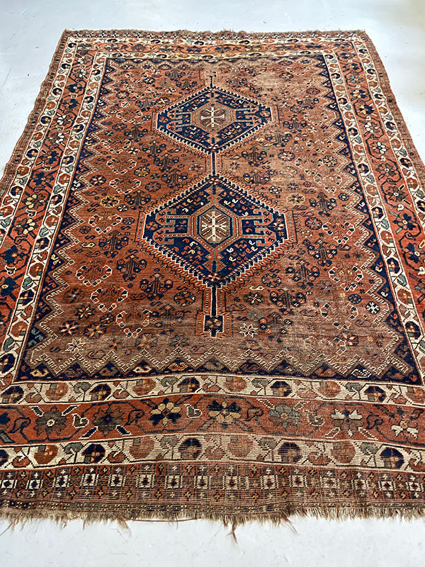 Decorative rug with intricate patterns on a white background